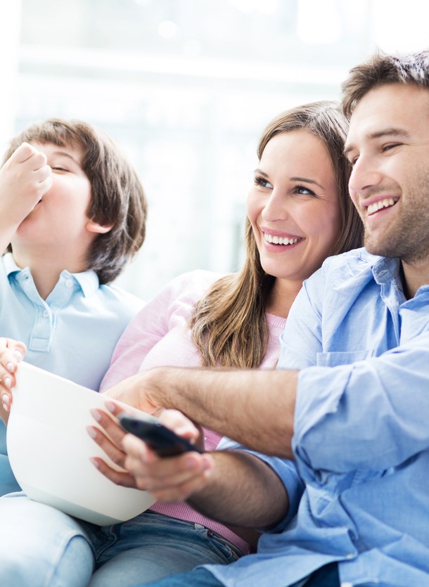 Boy sitting on sofa watching something on a tablet device